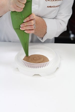 Pipe the prepared chocolate mousse into the Silikomart
