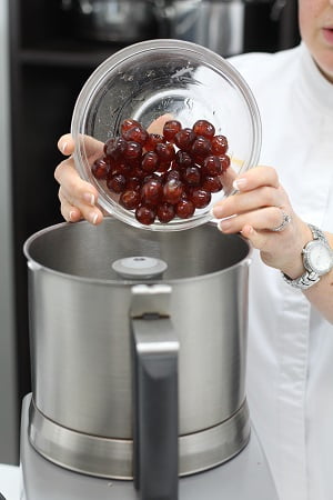cherries and raspberry jam into a food processor